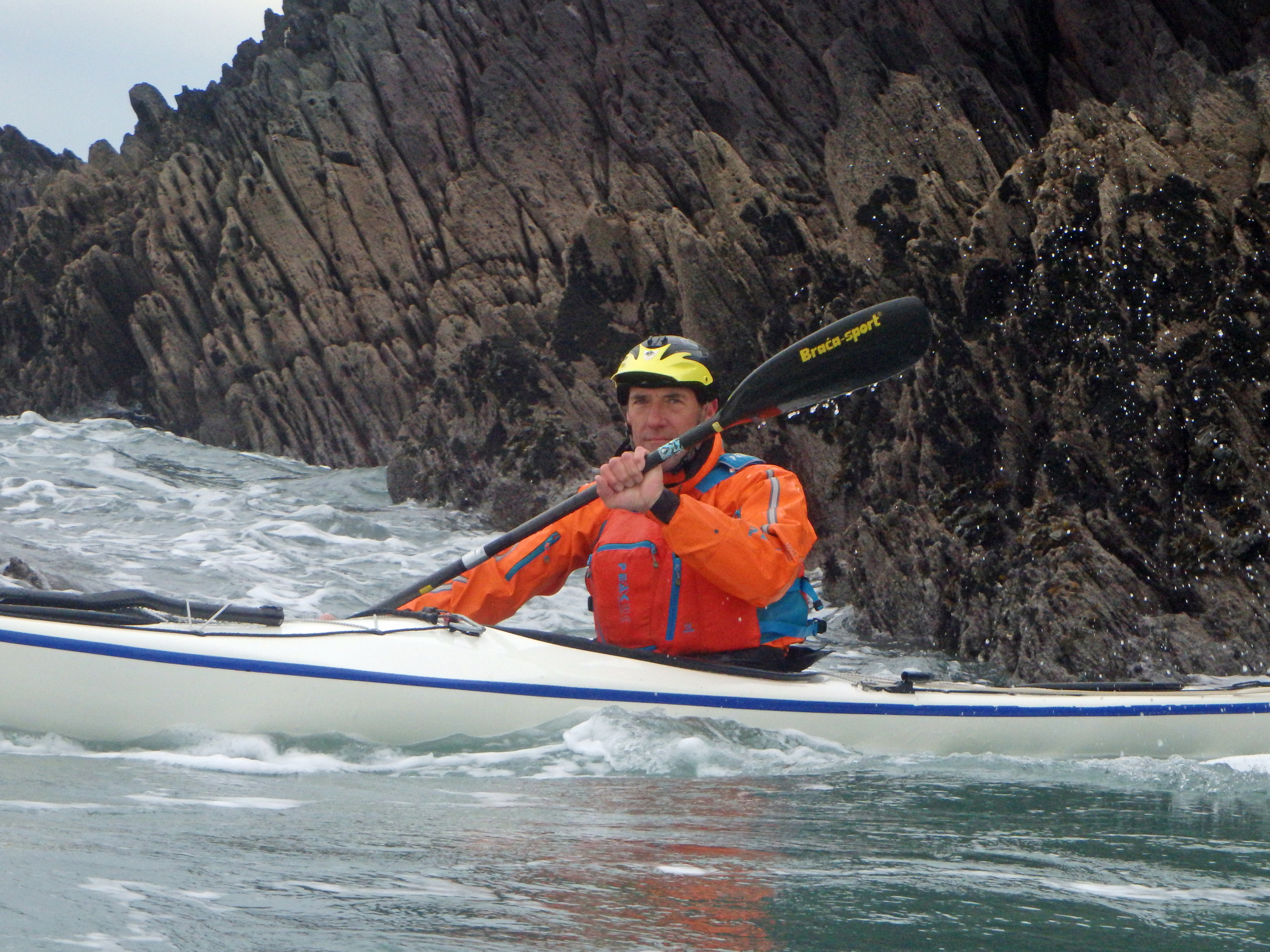 Ian smiling in a kayak on the water